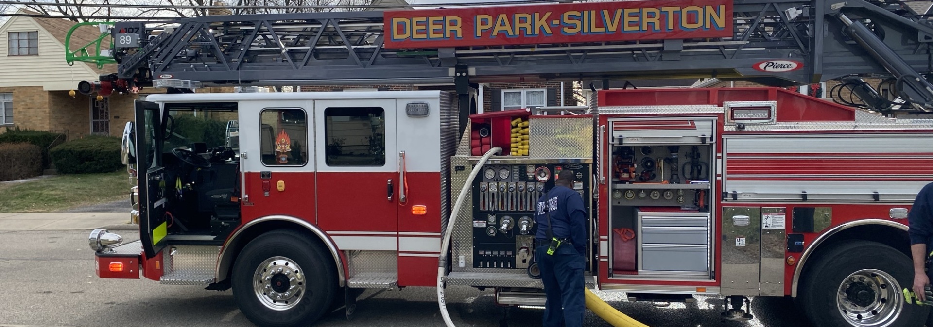 Fire truck with firefighter working on truck 
